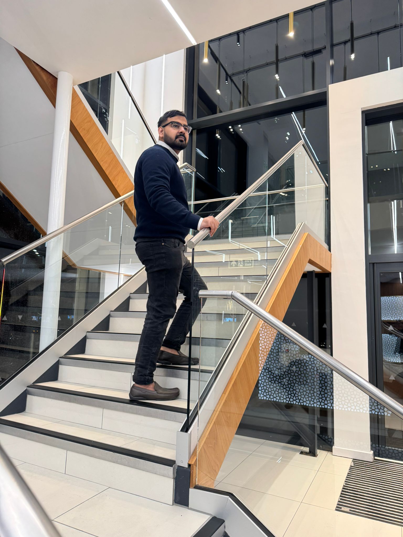 Rizwan Saleem walking over stairs in Oldham Manchester